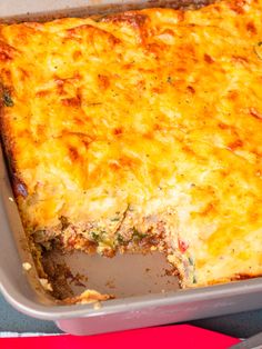 a casserole dish with cheese and broccoli in it