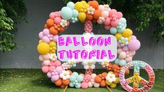 balloon decoration in the shape of a peace sign with balloons around it and a peace sign