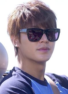 a young man wearing sunglasses while sitting in a car