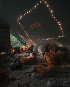 a room filled with lots of pillows and lights