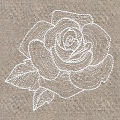 a white rose embroidered onto a tan linen background with the outline of a flower on it