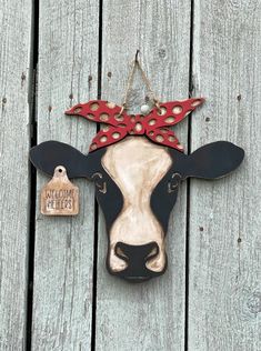 a cow head hanging on the side of a wooden fence