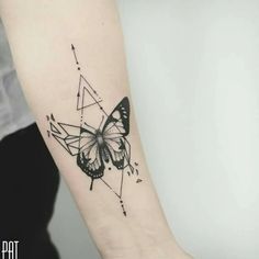 a black and white butterfly tattoo on the left inner arm, with geometric shapes around it