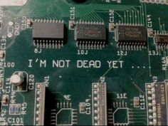 an electronic board with some microchips on it that says i'm not dead yet