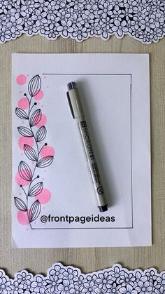 a pen sitting on top of a piece of paper next to an envelope with flowers