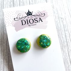 Green and Yellow Shiny Round Button Shaped Stud Earrings These eye-catching, round shiny studs are handmade and so easy to pair with any outfit. Fresh and vibrant colours that will complement your style. The resin and custom glitter combination are carefully mixed and hand-poured, then cured with a stunning, shiny domed finish. Every pair is unique and slightly different due to the nature of resin. Note that your pair of studs may be slightly different to those in the photographs.  1.6 cm diameter Green Round Plug Earrings Gift, Green Round Plug Earrings As Gift, Handmade Green Round Clip-on Earrings, Green Round Clip-on Earrings For Gift, Green Round Clip-on Earrings As Gift, Green Circle, Unique Handmade Earrings, Geometric Studs, Custom Glitter