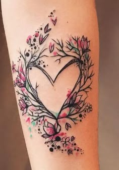 a heart shaped tattoo with flowers and leaves