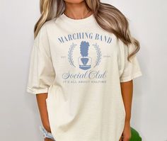 Show your pride as a Band Mom with this stylish and comfortable Marching Band Social Club T-Shirt. Perfect for all the halftime shows and band events, this tee is a must-have for any proud marching band mom. 🎺 -Stylish design: Features a unique Marching Band Social Club graphic that stands out. -Versatile wear: Ideal for casual outings, band practices, and performances. -Perfect gift: Great for birthdays, holidays, or any special occasion for band   moms. Celebrate every halftime in style and s Marching Band Must Haves, Funny Marching Band Shirts, Marching Band Party Ideas, Spring School Spirit T-shirt For Streetwear, Spring School Spirit Streetwear T-shirt, Spring Fan Merchandise T-shirt, Spring Band Logo Graphic Tee, Spring Streetwear T-shirt With School Spirit Style, Spring Fan Apparel Tops