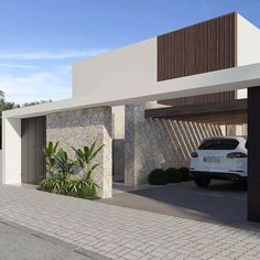 a white car is parked in front of a modern house with stone and wood accents