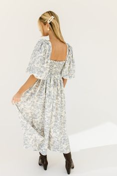 the search for the perfect all-season wedding guest dress is over. this stunning puff sleeve midi dress features a blue floral pattern + a flirty corset-inspired bodice. guaranteed to turn heads with every wear, it’s a must-have for cocktail parties, holiday dinners, or anytime you feel like frolicking. blue floral // midi length, scoop neckline, dramatic puff sleeves, back zipper closure, smocked bodice, fully lined model is 5'8" + wearing a small measurements are approximate + taken while layi Brunch Floral Print Midi Dress With Puff Sleeves, Puff Sleeve Midi Dress With Floral Print For Brunch, Puff Sleeve Floral Midi Dress For Brunch, Blue Floral Print Midi Length Puff Sleeve Dress, Blue Floral Print Puff Sleeve Midi Dress, Puff Sleeve Floral Dress With Smocked Bodice For Brunch, Blue Floral Print Midi Dress With Puff Sleeves, Puff Sleeve Maxi Dress With Floral Print For Brunch, Floral Print Puff Sleeve Maxi Dress For Brunch