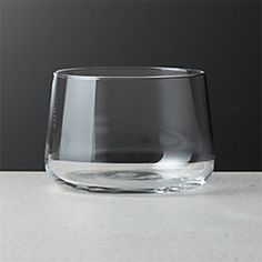 a clear glass sitting on top of a counter next to a gray and white wall