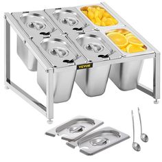 a stainless steel table with four trays and spoons