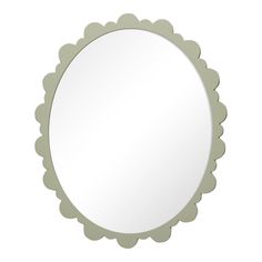 a round mirror with scalloped edges on a white background