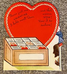 a valentine's day card with a box of chocolates in the shape of a heart