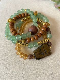 Layered  Green Jade, Amber Glass and Foil. Leafed wood beads, Gold Tibetan Accent Beads with Dragonfly Pendant Bracelets on durable stretch cord. Sold as a complete set of four bracelets! Earthy Beaded Jewelry, Layered Bracelets Aesthetic, Earthy Bracelets, Afro Jewelry, Boho Couches, Stacked Beaded Bracelets, Afrocentric Jewelry, Streetwear Jewelry, Earthy Jewelry