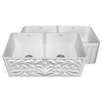 two white sinks sitting side by side on top of each other, one with an intricate design