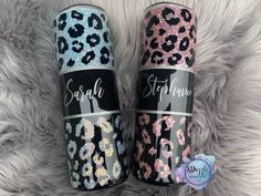 two personalized tumbles with leopard print on them, one is pink and the other is blue