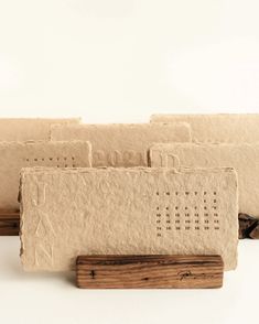 four pieces of carved wood sitting on top of each other in front of a white background