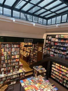 the inside of a bookstore with many books on shelves and tables in front of it