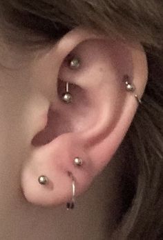 a woman with three piercings on her ear