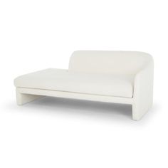 a white couch sitting on top of a white floor