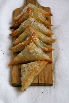 some food is sitting on a wooden board