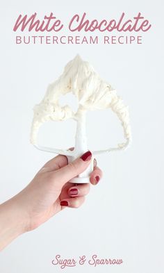 a hand holding a white chocolate buttercream recipe