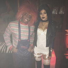 two people dressed up in costumes standing next to each other with makeup on their faces