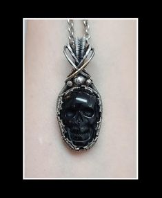 This pendant is made with a black obsidian skull that is wrapped in solid sterling silver which has been oxidized and polished for an antiqued look.  There are spider web details framing the stone.  This pendant is approximately 1 7/8 inches tall. Please see photos for exact measurement.  This pendant will include a complimentary 20 inch stainless steel necklace and it will arrive in a gift box. Black Gothic Sterling Silver Jewelry, Black Gothic Jewelry With Oxidized Finish, Black Engraved Jewelry For Halloween, Engraved Black Jewelry For Halloween, Black Sterling Silver Skull Jewelry, Black Skull Sterling Silver Jewelry, Black Skull Shaped Engraved Jewelry, Black Skull-shaped Engraved Jewelry, Black Engraved Skull Jewelry