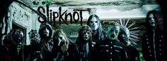 a group of people standing in front of a wall with the word slipknot on it