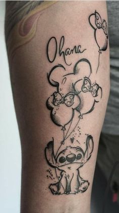 a person with a tattoo on their arm that says, ohana and an elephant holding balloons