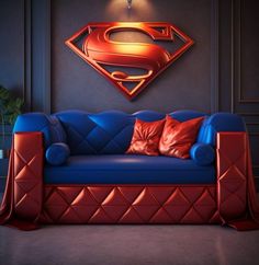 a blue couch with red pillows and a superman symbol on the wall behind it in a dark room