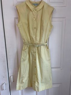 Adorable vintage 50s/60s button down summer dress.  Despite being in not great condition (several marks pictured), it's still so cute! Could probably improved with the right care/products. Sold as is. Measurements taken flat: Waist: 13" Pit to pit: 17" Waist to hem: 20" Top of neck to waist: 16" Shoulder to shoulder: 15" Vintage A-line Dress With Buttons, Vintage Sleeveless Buttoned Dress, Vintage Sleeveless Dress With Buttons, 1950s A-line Vintage Summer Dress, Retro Vintage Dress With Button Closure, 1950s Vintage Dress For Summer, 1950s Style Vintage Dress For Summer, Retro Button-up Summer Dress, 1950s Style Sleeveless Button Dress