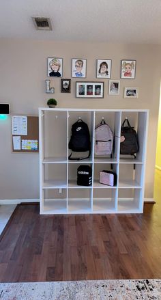 a white bookcase filled with lots of bags