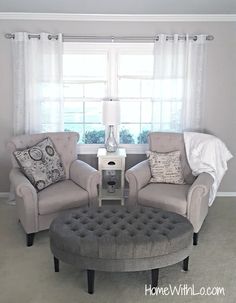 a living room with two couches and a coffee table in front of a window