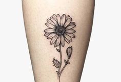 a sunflower tattoo on the leg