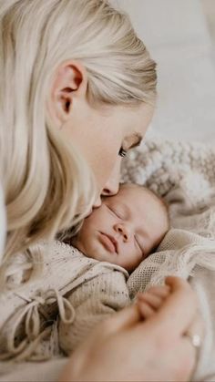 a woman holding a baby in her arms and kissing it's face with the caption that reads, i love you so much