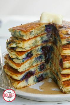 a stack of pancakes with blueberries and butter on top