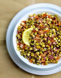 a white bowl filled with food on top of a table