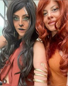 two women dressed up in costumes posing for the camera