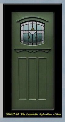 a green front door with two windows on the top and bottom side, in black frame