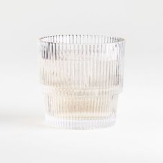 a clear glass cup sitting on top of a white table