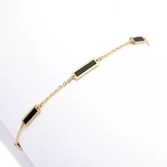 Add a gorgeous splash of color and style to any look with this Sabrina Designs bracelet. It beautifully displays six 7.5mmx1.65mm rectangular gemstone inlays. Choose from turquoise, malachite, mother-of-pearl or onyx. It's crafted in 14K yellow gold with a polished finish that provides brilliant shine. The 7" cable link chain safely secures with a spring ring clasp. It's the perfect finishing touch whenever you want to add eye-catching color to your look, whether you're going casual or dressing Elegant Rectangular Bracelets With Polished Finish, Elegant Adjustable Jewelry With Rectangular Stone, Elegant Black Bracelets In 14k Gold, Elegant Black 14k Gold Bracelets, Elegant Black Jewelry With Rectangular Links, Elegant Black Jewelry With Bracelet Strap, Elegant Bracelet With Rectangular Stone For Gift, Modern Gold Bracelets With Black Enamel, Modern Rectangular Gold Bracelet With Polished Finish