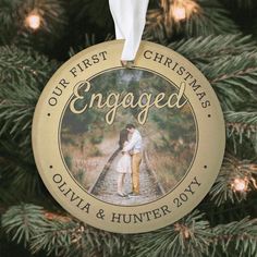 an engaged ornament hanging on a christmas tree