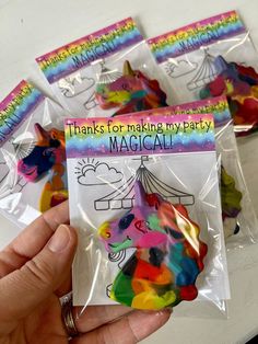 there is a bag of plastic magnets in the shape of a unicorn with rainbow colors