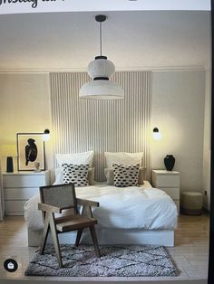 a bedroom with white bedding and black accents