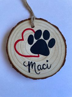 a wooden ornament with a dog's paw and heart