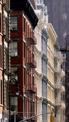 a row of buildings with fire escapes on each side