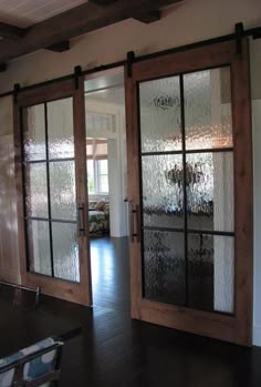 an empty room with glass doors and chairs