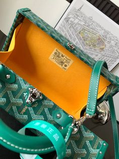 a green and yellow purse sitting on top of a table